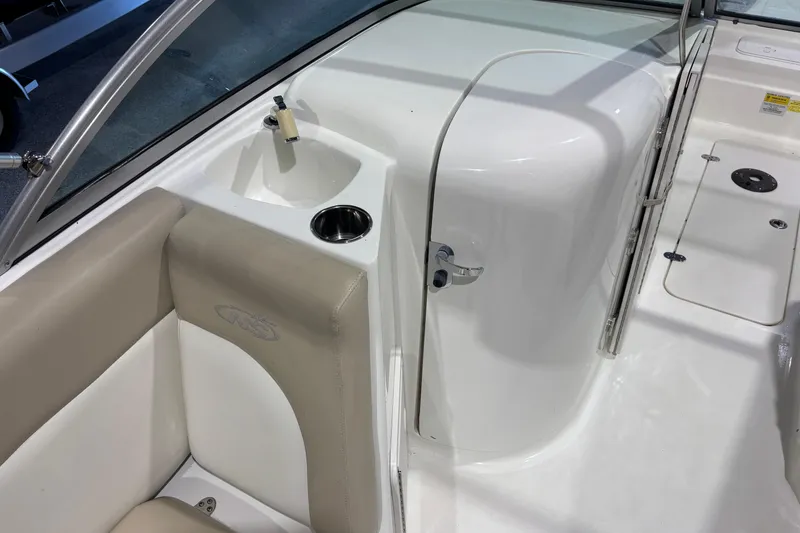 Slide: The Image of 2015 NauticStar 223DC Sport Deck interior with sink and seating area. - 9