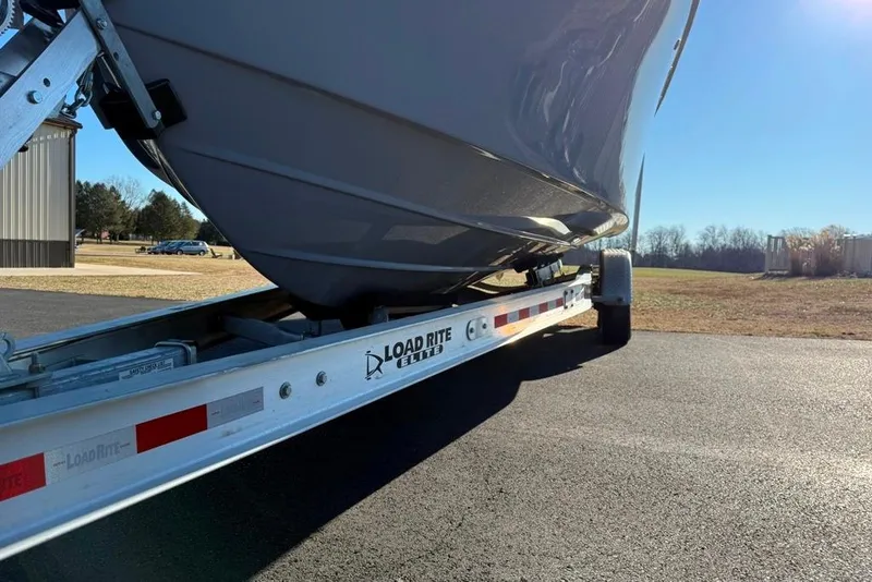 Slide: The Image of 2024 Parker 2820 XLD Sport Cabin boat on Load Rite trailer, parked outdoors. - 4