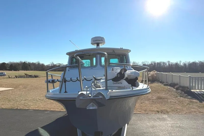 Slide: The Image of 2024 Parker 2820 XLD Sport Cabin boat with Garmin equipment, parked outdoors under clear sky. - 5