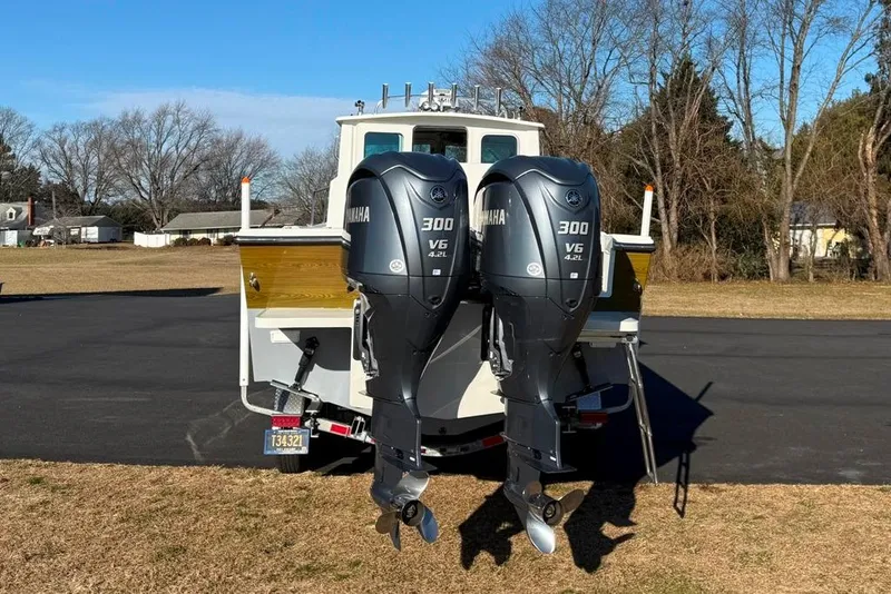 Slide: The Image of 2024 Parker 2820 XLD Sport Cabin with dual Yamaha 300 V6 engines, parked outdoors. - 7