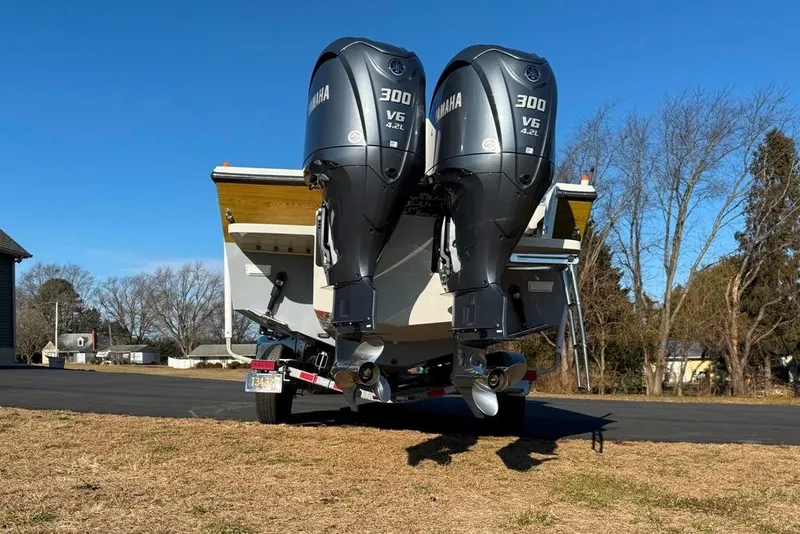 Slide: The Image of 2024 Parker 2820 XLD Sport Cabin with dual Yamaha 300 V6 engines on trailer. - 8