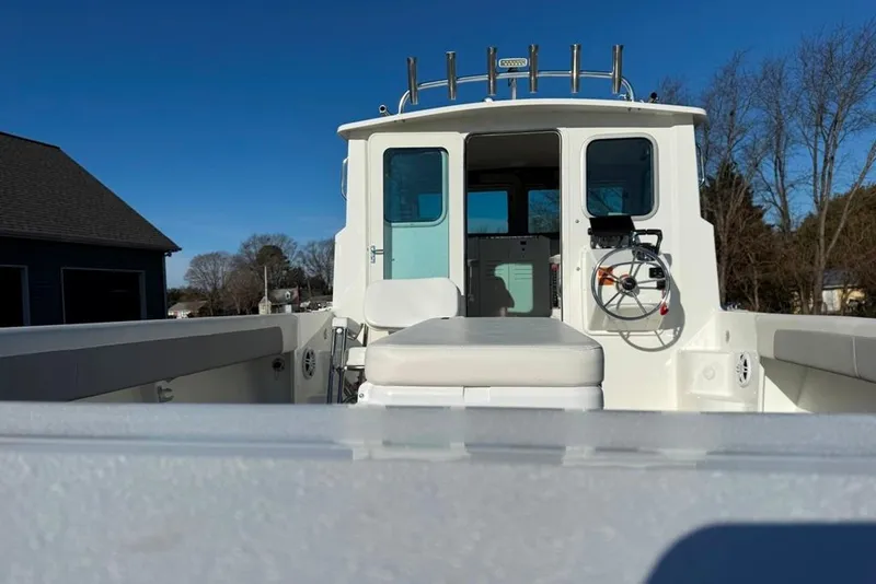 Slide: The Image of 2024 Parker 2820 XLD Sport Cabin boat, white exterior, clear sky background. - 9