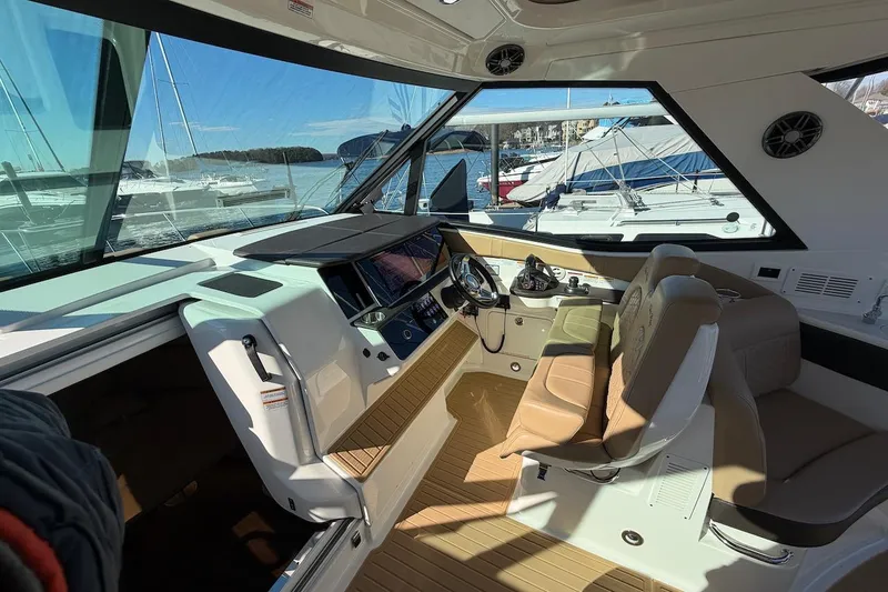 Slide: The Image of Interior of 2023 Sea Ray Sundancer 320 Outboard, featuring modern helm and seating. - 19