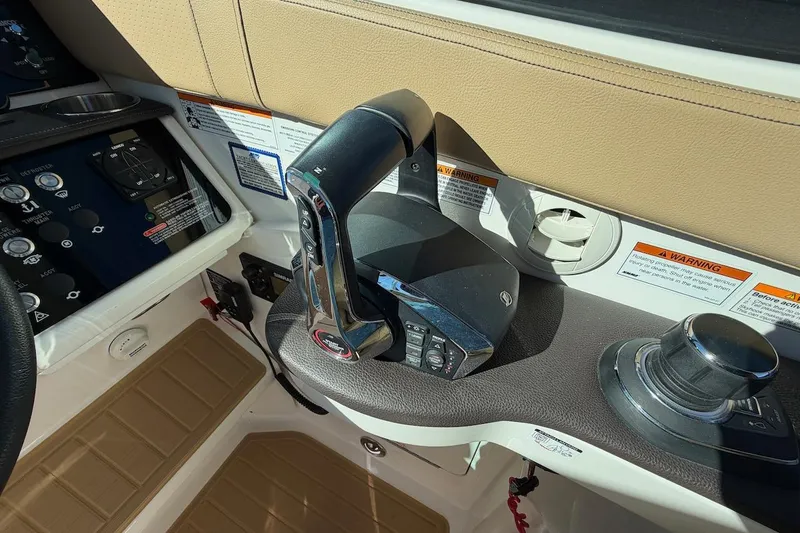 Slide: The Image of 2023 Sea Ray Sundancer 320 Outboard helm controls with throttle and joystick. - 24