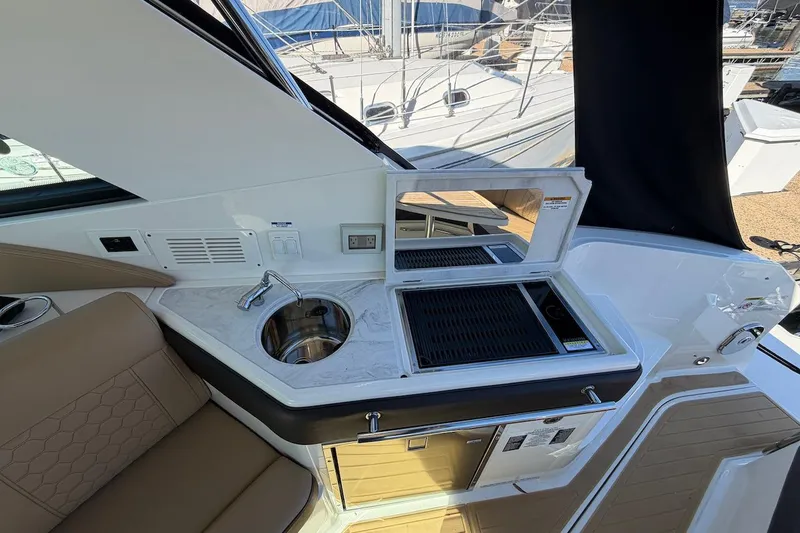 Slide: The Image of 2023 Sea Ray Sundancer 320 Outboard boat interior with sink and grill station. - 25