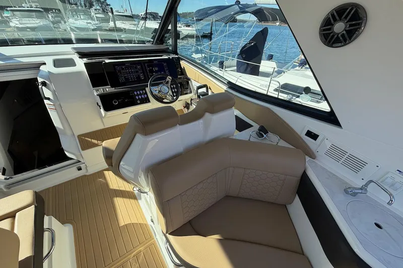 Slide: The Image of 2023 Sea Ray Sundancer 320 Outboard cockpit with modern controls and luxurious seating. - 26