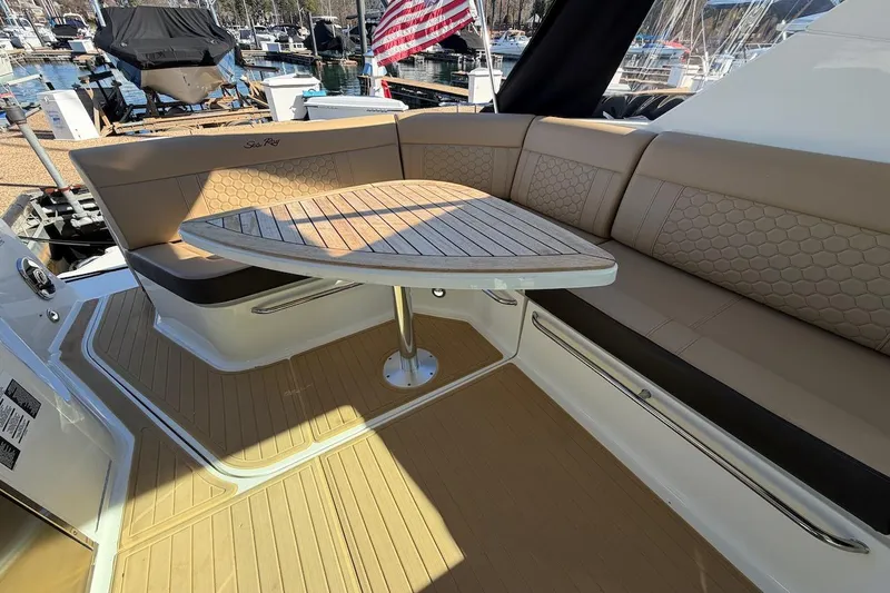 Slide: The Image of 2023 Sea Ray Sundancer 320 Outboard interior with elegant seating and wooden table. - 28