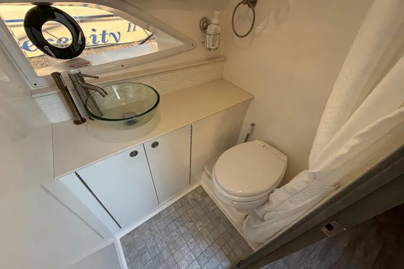 Slide: The Image of 2023 Sea Ray Sundancer 320 Outboard bathroom with modern sink and toilet. - 34