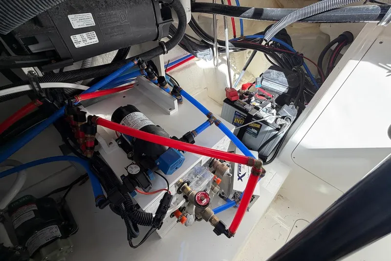 Slide: The Image of Engine compartment of 2023 Sea Ray Sundancer 320 Outboard with wiring and battery setup. - 39