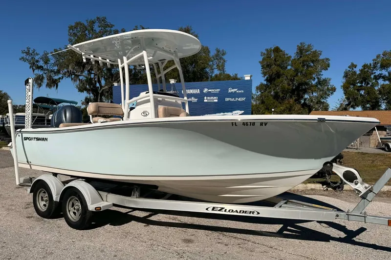 The Image of 2019 Sportsman Open 212 Center Console boat on trailer, parked outdoors. - 0