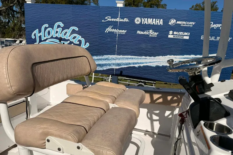 Slide: The Image of 2019 Sportsman Open 212 Center Console boat interior with steering wheel and cushioned seating. - 6