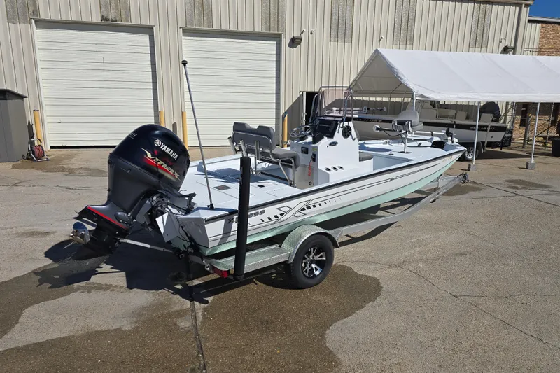 Slide: The Image of 2022 Xpress H20B Bay boat with Yamaha engine on trailer. - 11