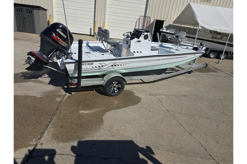 Slide: The Image of 2022 Xpress H20B Bay boat on trailer with Yamaha outboard motor. - 2