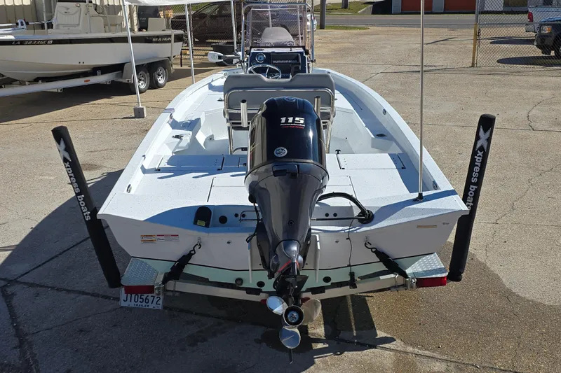 Slide: The Image of 2022 Xpress H20B Bay boat with 115 horsepower engine, parked on a trailer. - 5