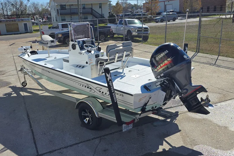 Slide: The Image of 2022 Xpress H20B Bay boat with Yamaha outboard motor on a trailer. - 6