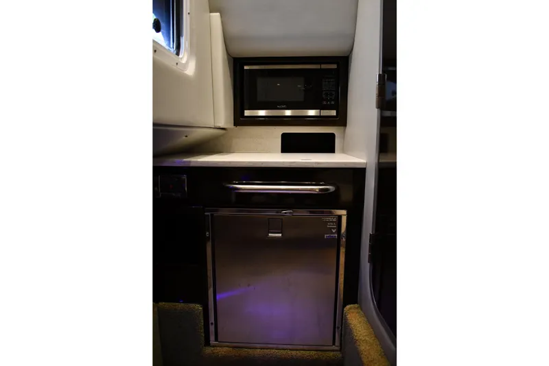 Slide: The Image of 2018 Formula 350 Crossover Bowrider OB interior with microwave and mini-fridge. - 10