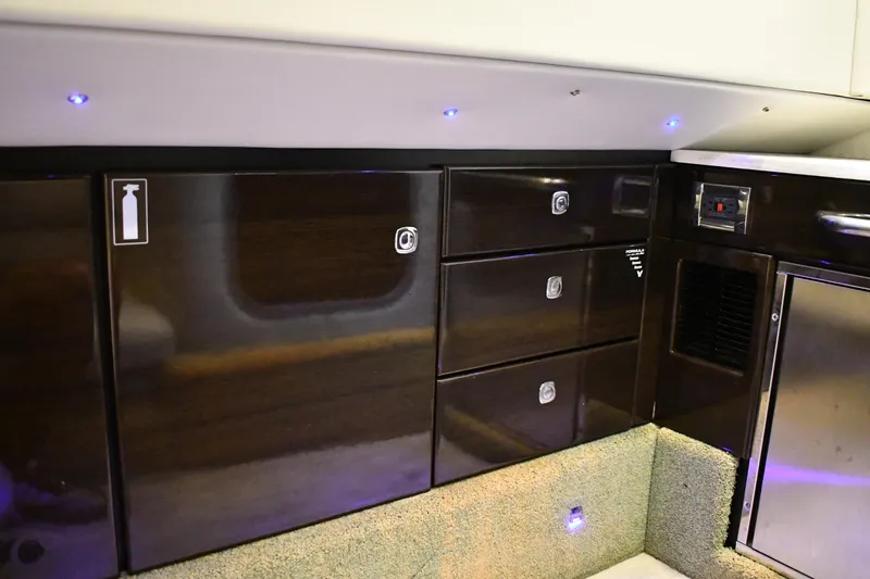 Slide: The Image of 2018 Formula 350 Crossover Bowrider OB interior with sleek dark wood cabinetry. - 11