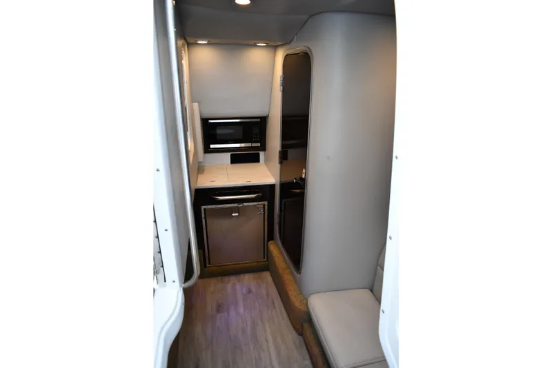 Slide: The Image of 2018 Formula 350 Crossover Bowrider OB interior with kitchenette and seating area. - 9