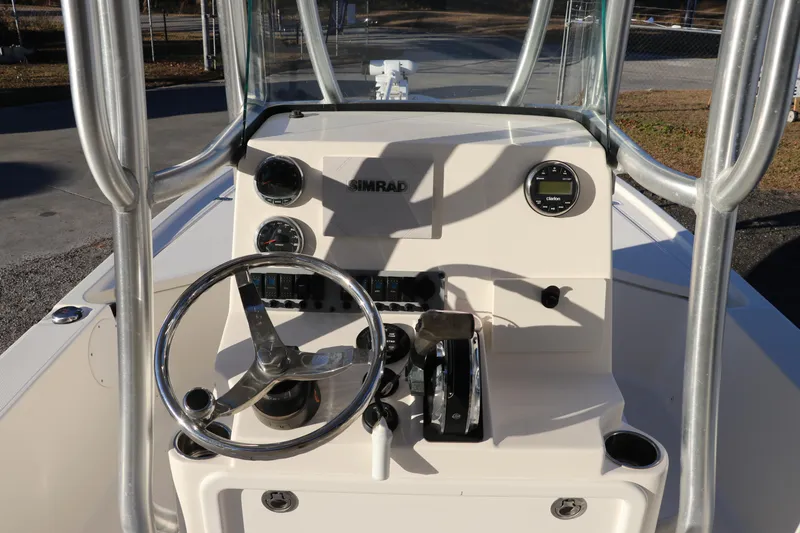 Slide: The Image of 2016 Sea Born FX21 Bay boat console with steering wheel and controls. - 11