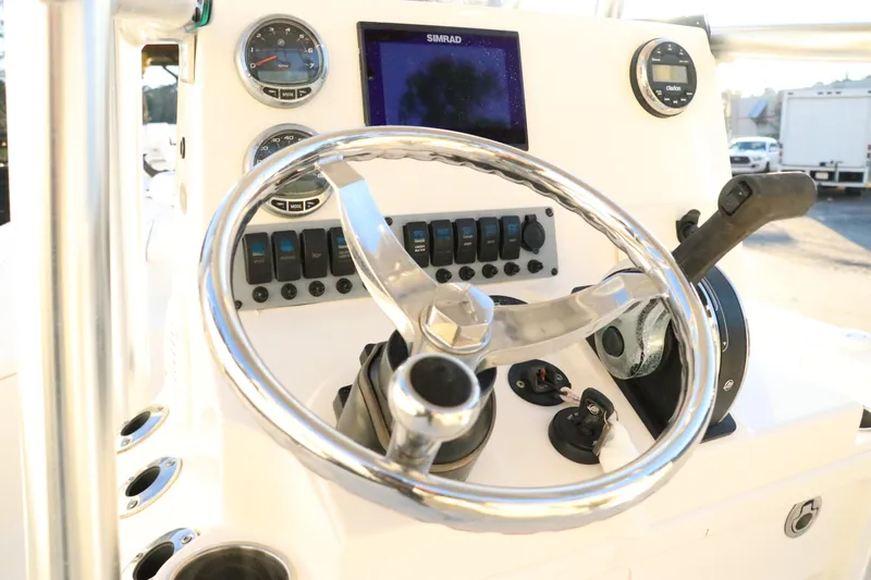 Slide: The Image of 2016 Sea Born FX21 Bay boat dashboard with steering wheel and control panel. - 12