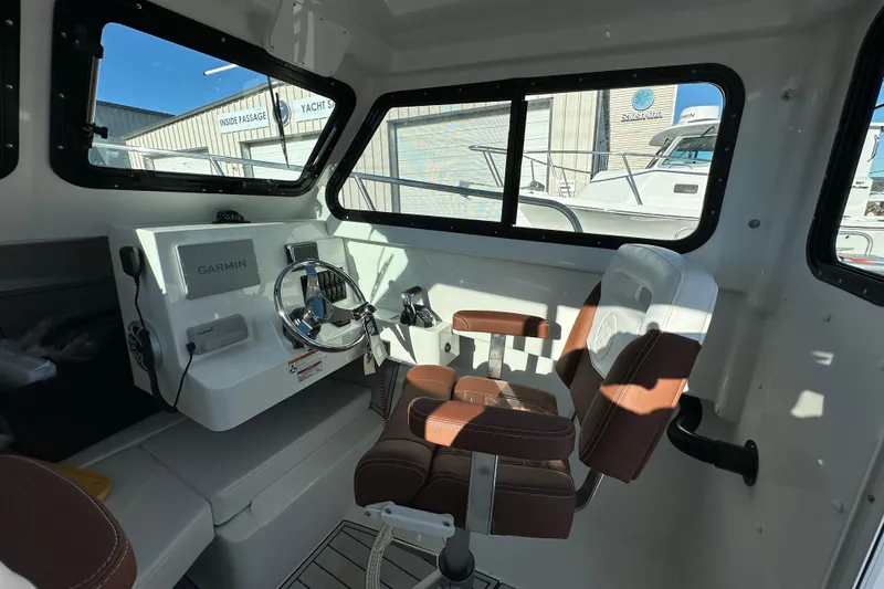 Slide: The Image of Interior of 2026 Parker 227 Explorer boat with Garmin navigation system and leather seating. - 10