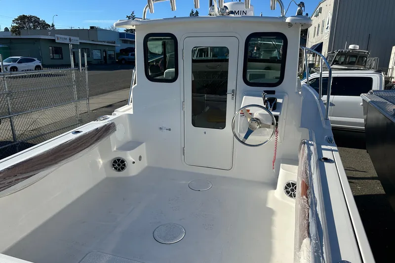 Slide: The Image of 2026 Parker 227 Explorer boat interior with steering wheel and seating area. - 16