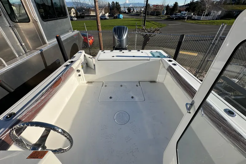 Slide: The Image of 2026 Parker 227 Explorer boat interior with steering wheel and outboard motor. - 17