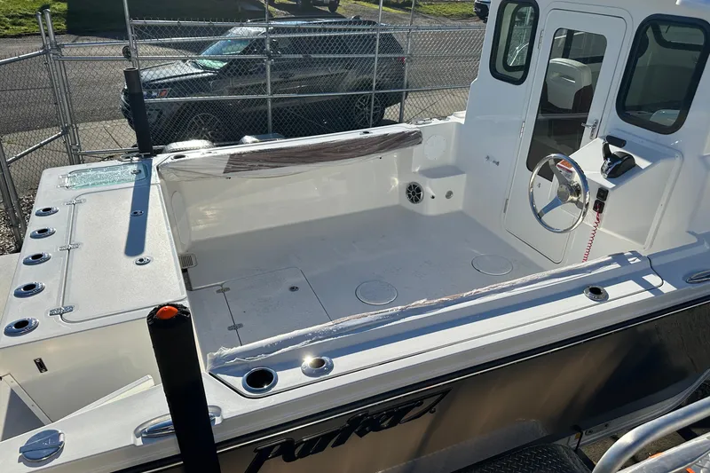 Slide: The Image of 2026 Parker 227 Explorer boat interior with steering wheel and seating area. - 19