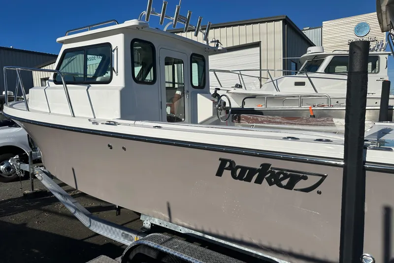 Slide: The Image of 2026 Parker 227 Explorer boat on trailer, displayed outdoors at a dealership. - 8