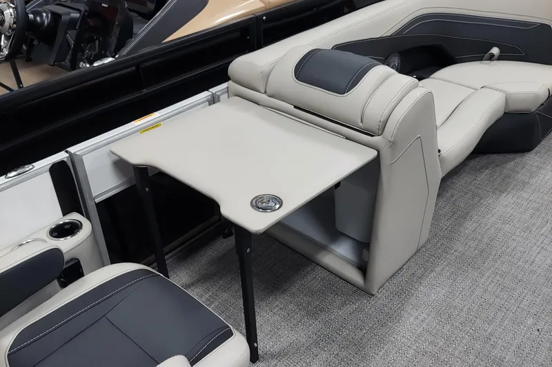 Slide: The Image of 2026 Barletta Cabrio 22UC interior with beige seating and foldable table. - 8