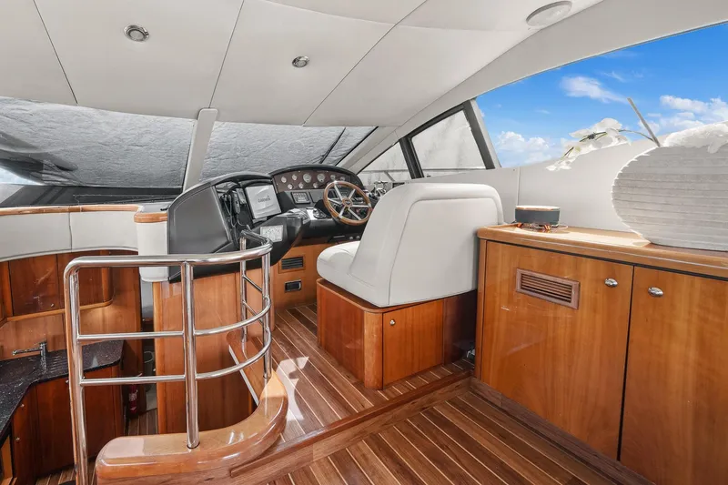 Slide: The Image of Luxurious interior of 2006 Sunseeker Manhattan 50 yacht with wooden finishes and modern helm. - 17