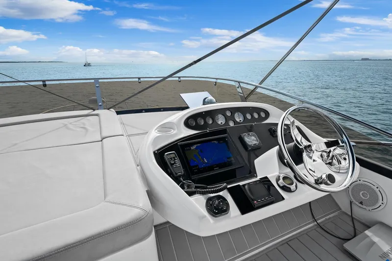 Slide: The Image of Helm of 2006 Sunseeker Manhattan 50 yacht with ocean view and navigation equipment. - 19