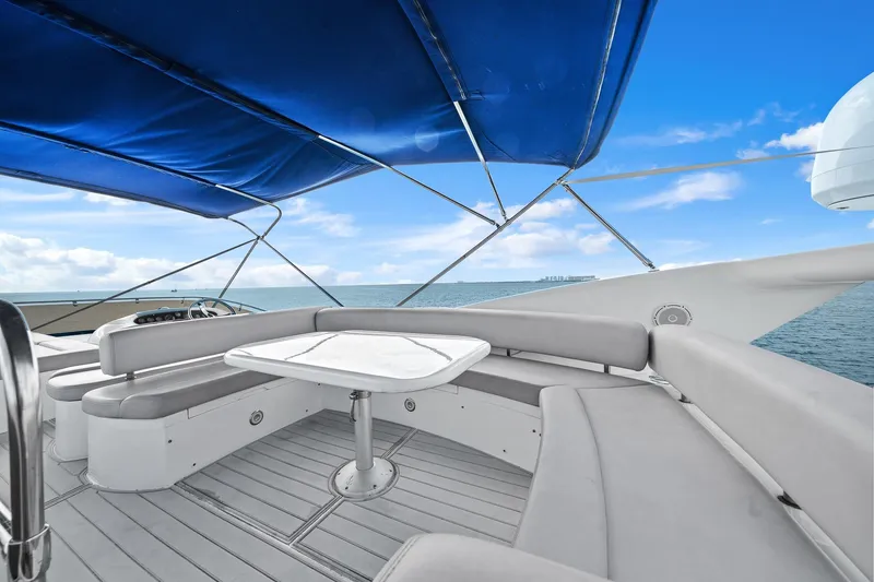 Slide: The Image of Luxurious Sunseeker Manhattan 50 yacht deck with seating, ocean view, and blue canopy, 2006 model. - 22