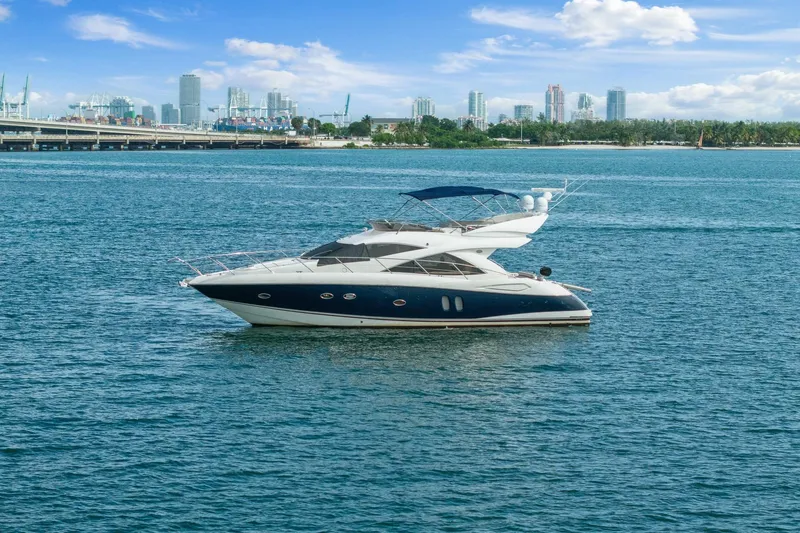 Slide: The Image of 2006 Sunseeker Manhattan 50 yacht on calm water with city skyline backdrop. - 3