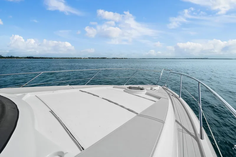 Slide: The Image of Bow view of 2006 Sunseeker Manhattan 50 yacht on open water under blue sky. - 34