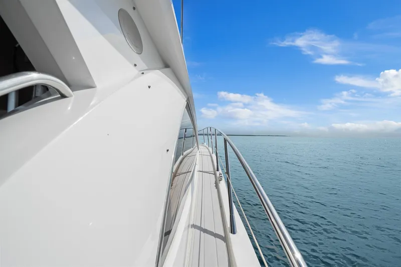 Slide: The Image of 2006 Sunseeker Manhattan 50 yacht cruising on calm blue waters under a clear sky. - 35