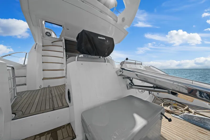 Slide: The Image of 2006 Sunseeker Manhattan 50 yacht deck with stairs, ocean view, and clear sky. - 36