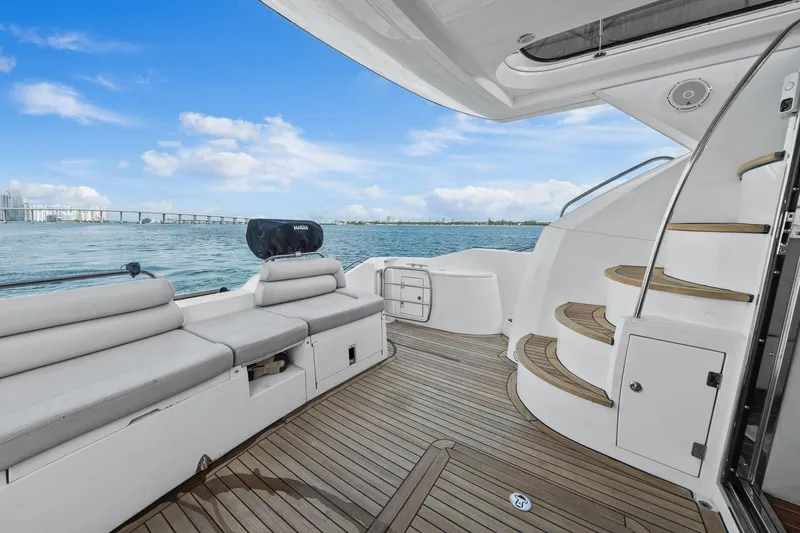 Slide: The Image of Luxury Sunseeker Manhattan 50 yacht deck with seating, ocean view, and elegant staircase, 2006 model. - 42