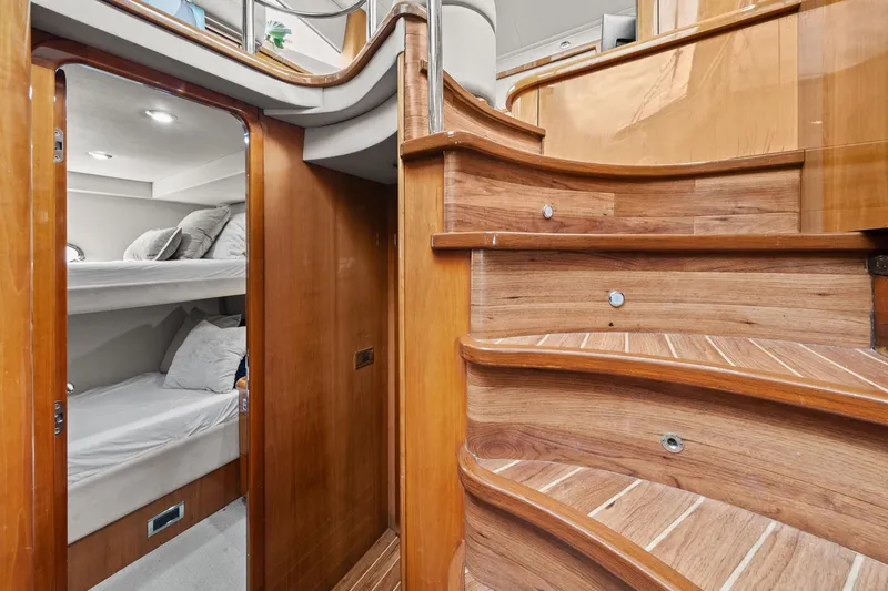 Slide: The Image of Interior of 2006 Sunseeker Manhattan 50 yacht with wooden stairs and cozy bunk beds. - 52