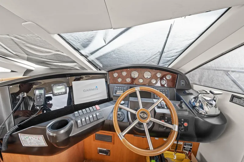 Slide: The Image of 2006 Sunseeker Manhattan 50 yacht helm with Garmin navigation system and classic steering wheel. - 9