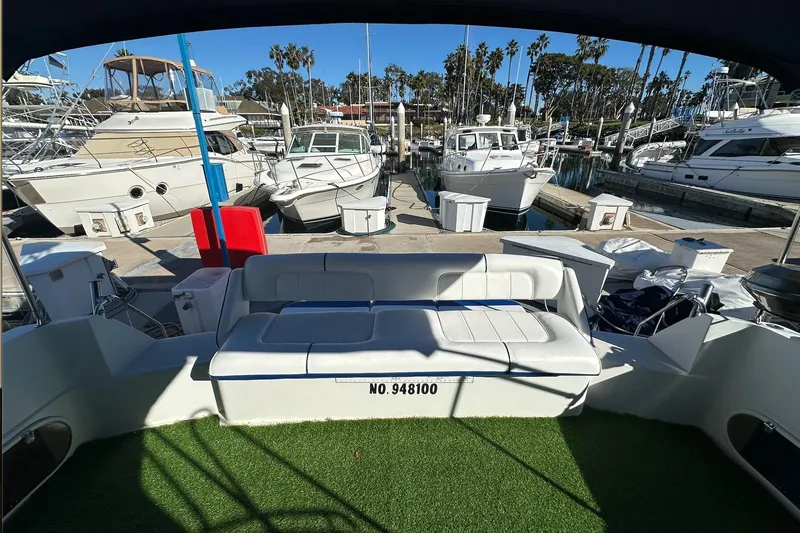 Slide: The Image of 1988 Carver 38 Santego yacht docked at marina with seating area and green carpet. - 10