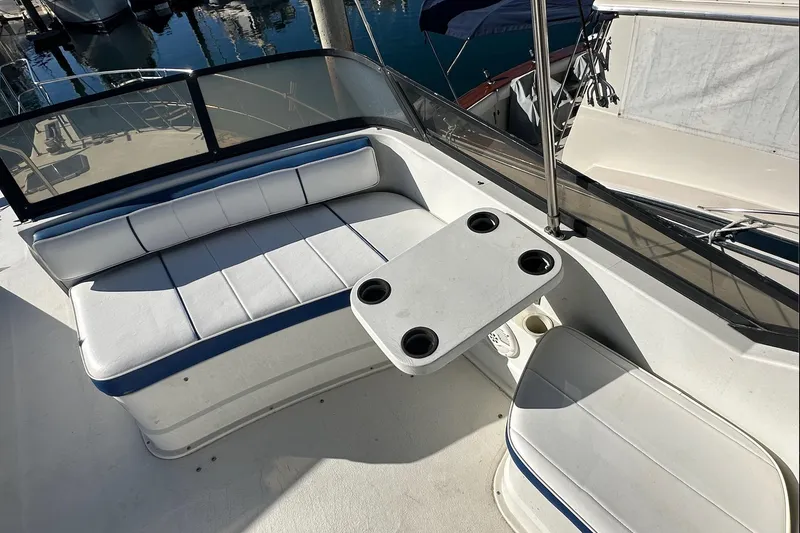 Slide: The Image of 1988 Carver 38 Santego boat seating area with table and cup holders. - 14