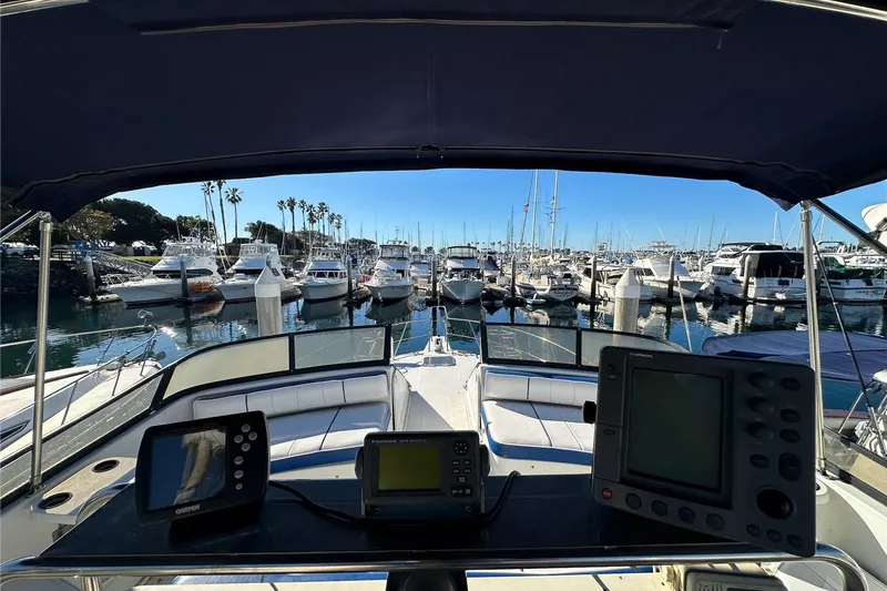 Slide: The Image of 1988 Carver 38 Santego yacht cockpit view at marina with navigation equipment. - 16