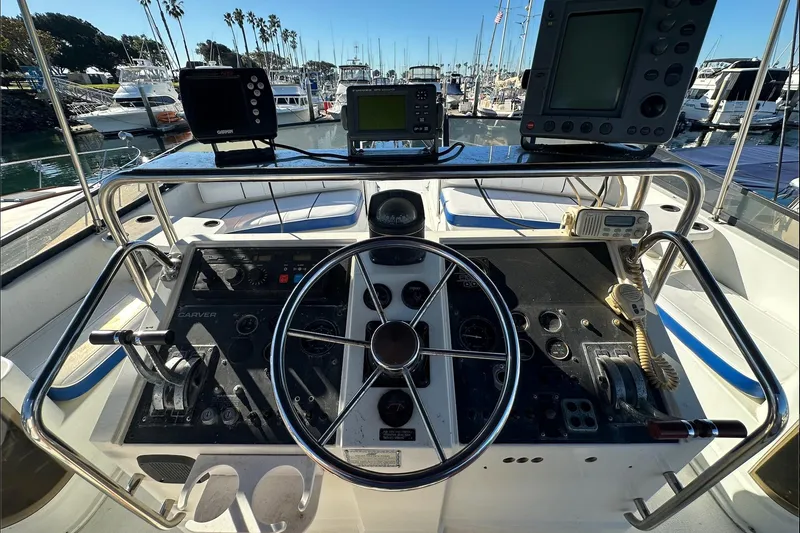 Slide: The Image of 1988 Carver 38 Santego helm with navigation equipment and marina view. - 17
