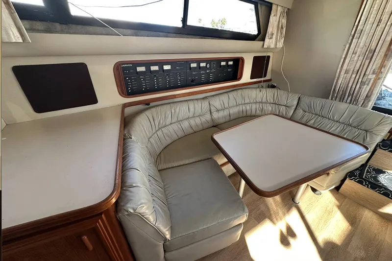 Slide: The Image of 1988 Carver 38 Santego yacht interior with cushioned seating and control panel. - 18