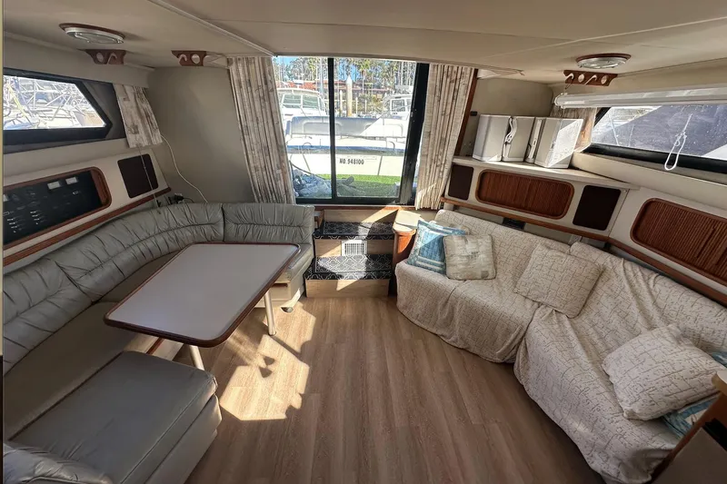 Slide: The Image of Interior of 1988 Carver 38 Santego yacht with cozy seating and large windows. - 19