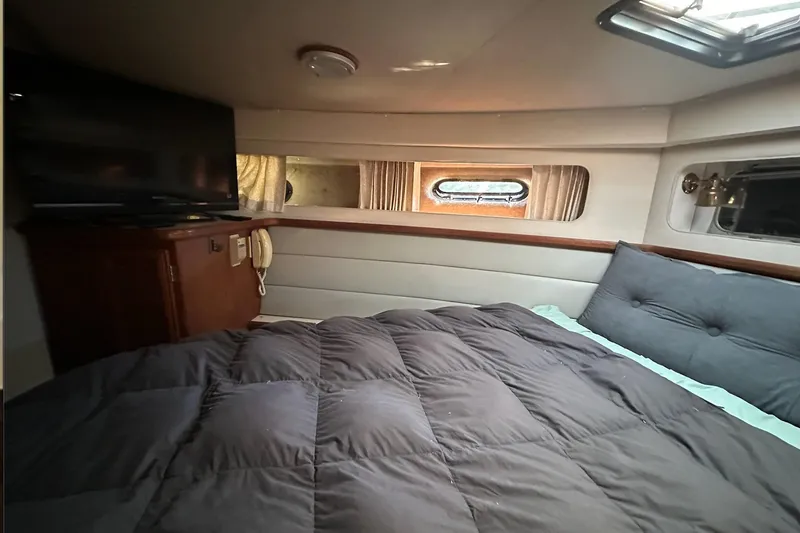 Slide: The Image of Interior cabin of 1988 Carver 38 Santego yacht with bed and TV. - 22