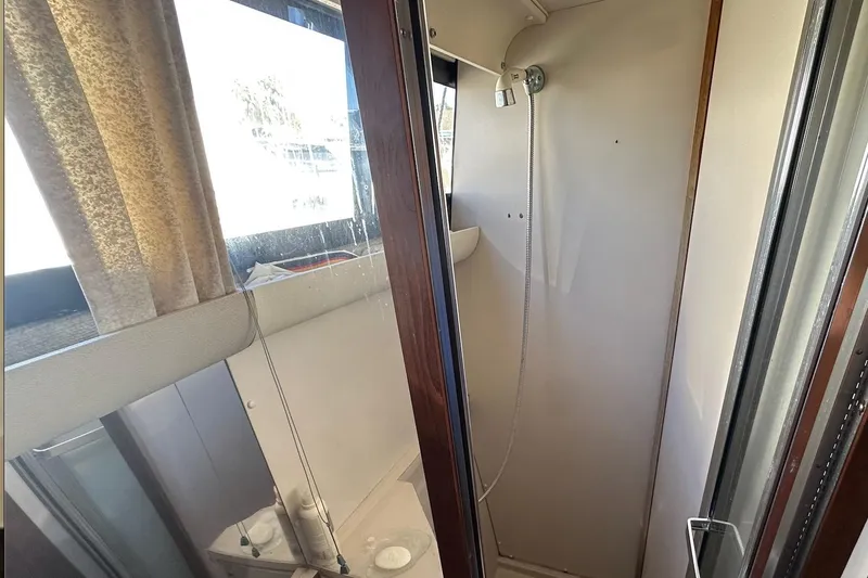 Slide: The Image of Shower area inside 1988 Carver 38 Santego boat, featuring a compact design. - 23