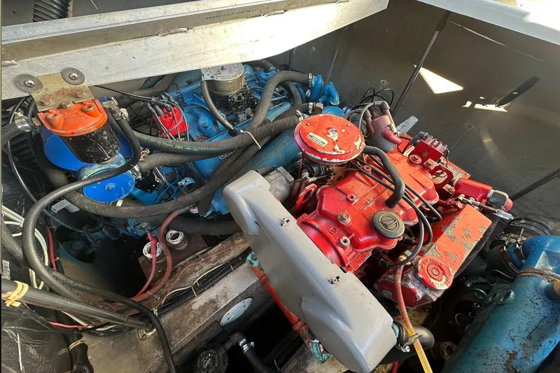 Slide: The Image of Engine compartment of a 1988 Carver 38 Santego boat, featuring red and blue components. - 25
