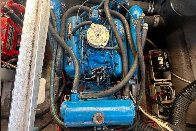 Slide: The Image of Engine compartment of a 1988 Carver 38 Santego with blue marine engine. - 26